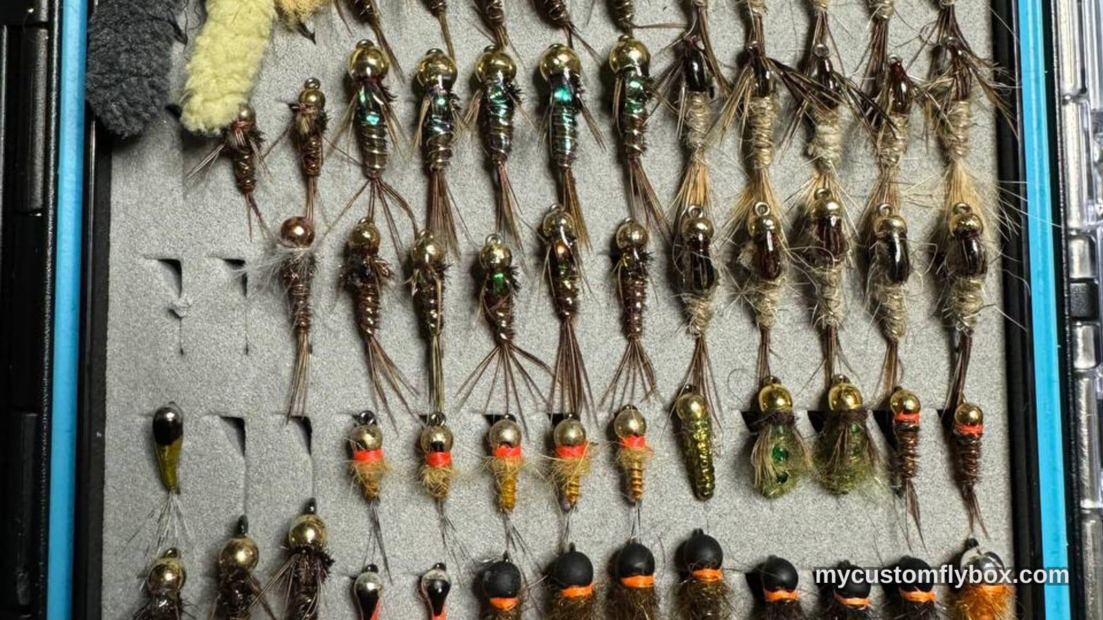 Open fly box packed with nymphs, jig flies, and trout patterns for fall fishing
